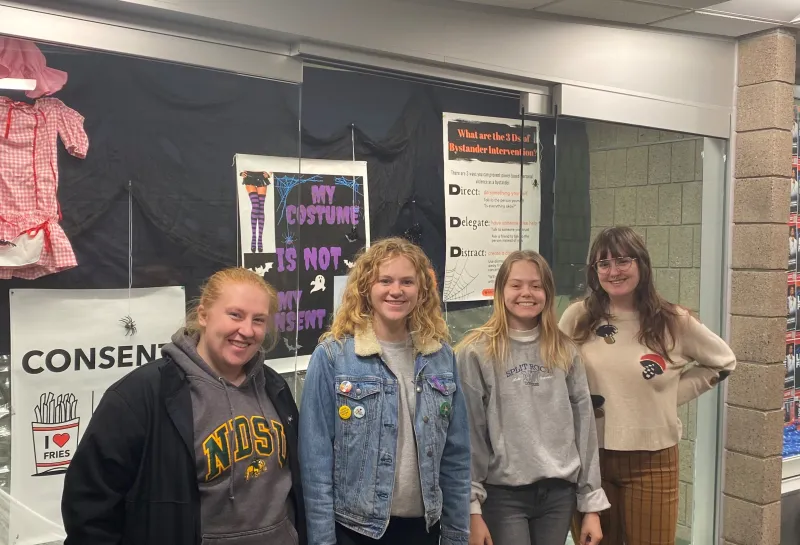 Students standing by Halloween Display Case