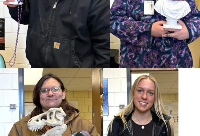 Four students holding science day prizes.