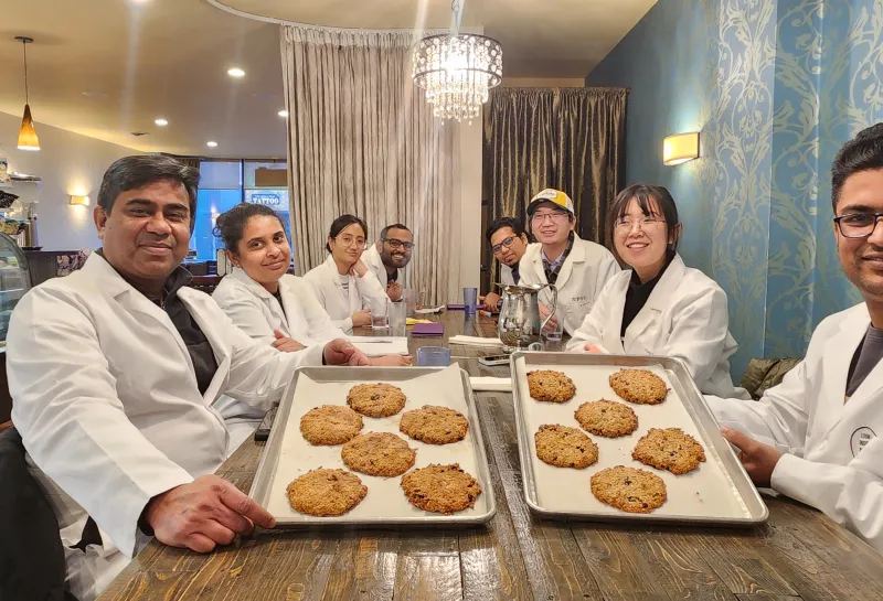 Dr. Shahidul Islam and his students posing with the cookies they made during Visit to Nichole's Bakery as a part of class