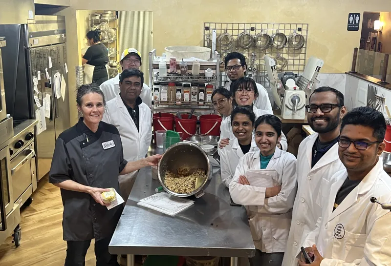 Students preparing cookies during Visit to Nichole's Bakery as a part of class
