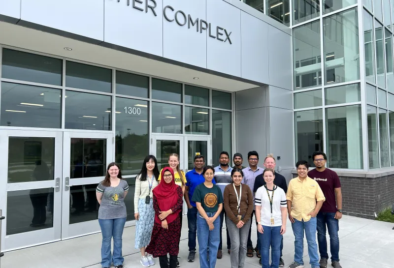 Group pivture of wheat quality lab in front of peltier complex, 2024