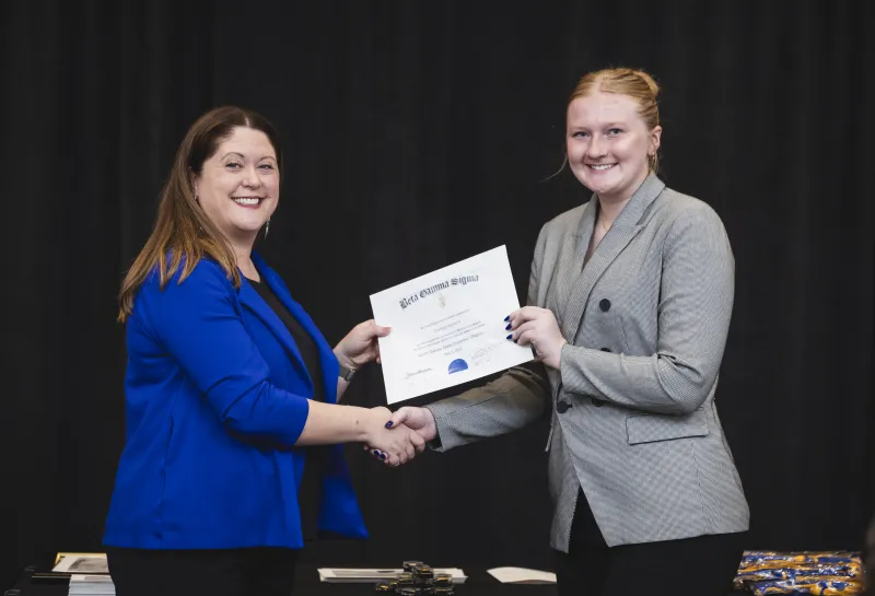 Kathryn Birkeland Presenting Certificate to Inductee