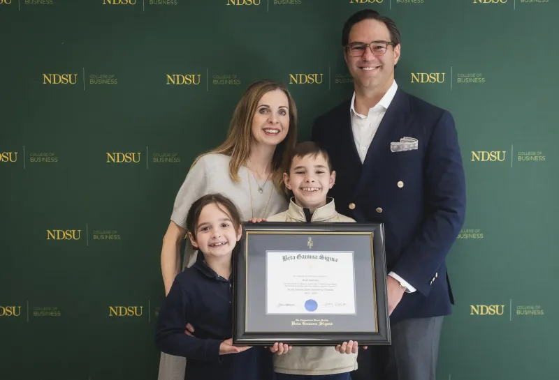 Brett Idderman with his family and Award