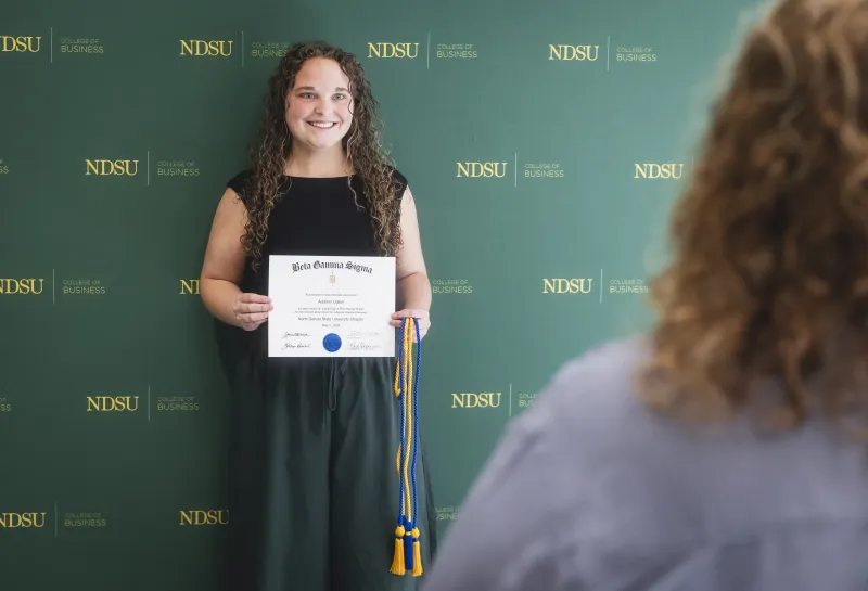 Inductee with certificate and cord