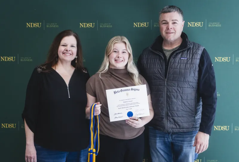 Inductee with her award, cord and family