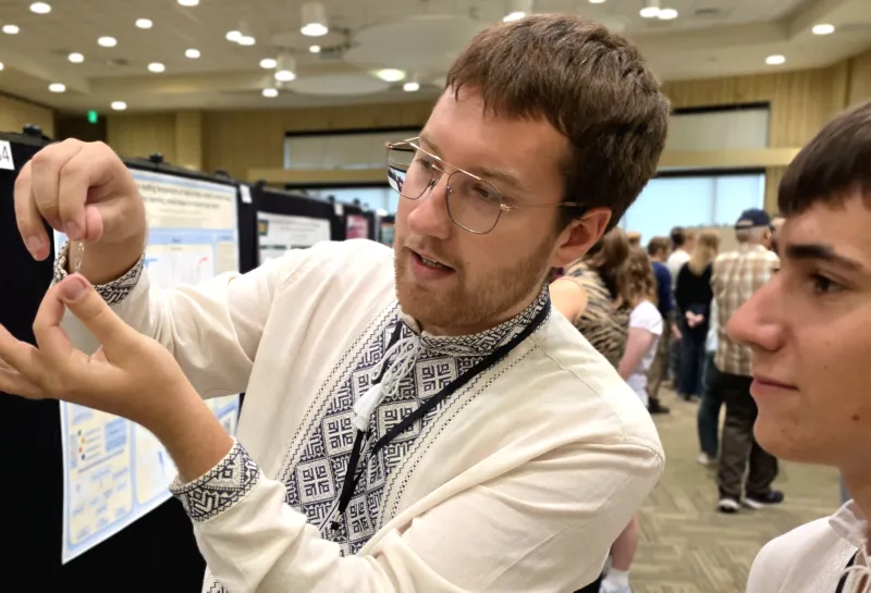 2026 summer REU students present their work at a poster session.