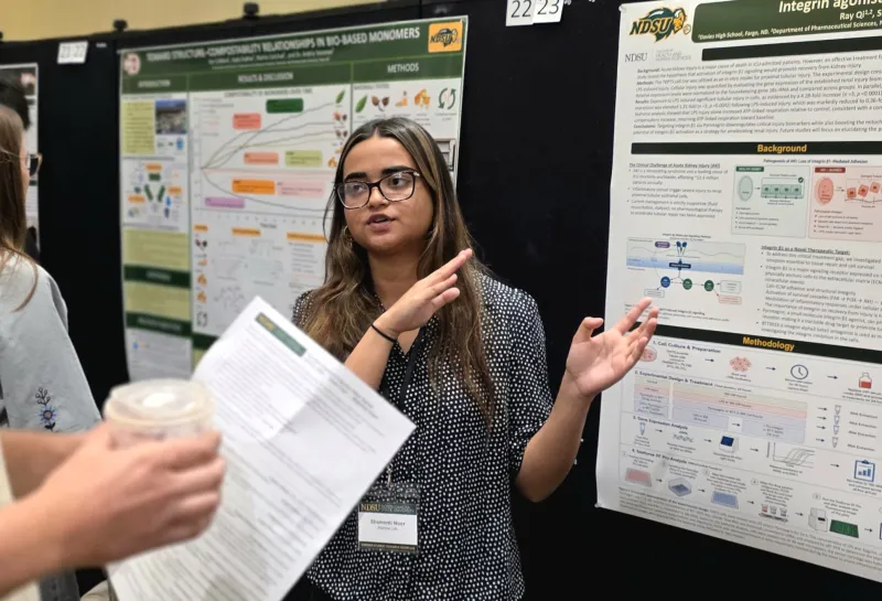 2026 summer REU students present their work at a poster session.