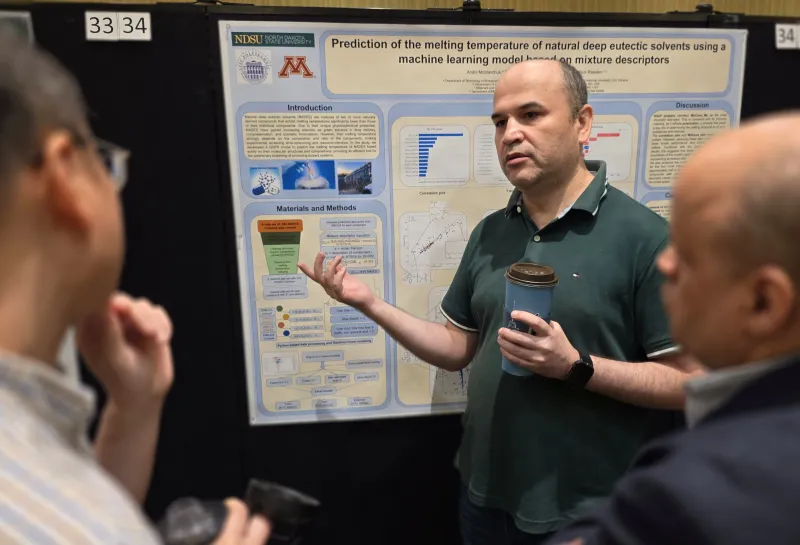 2026 summer REU students present their work at a poster session.