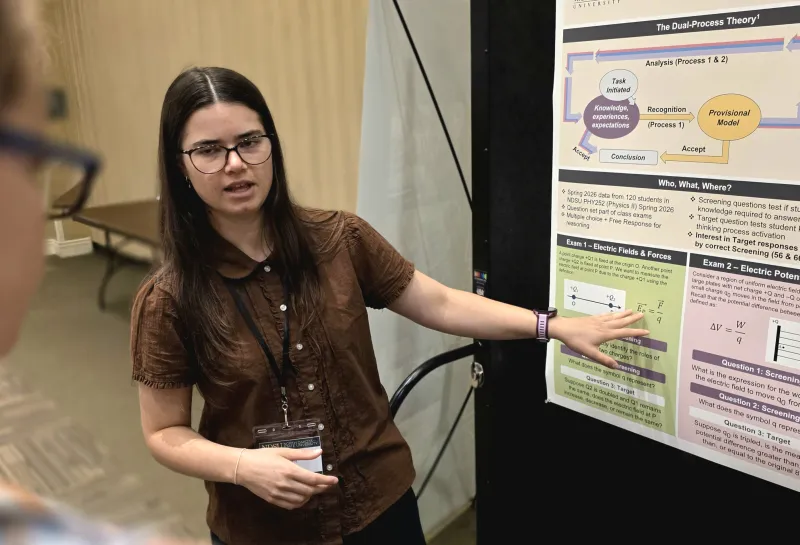 2026 summer REU students present their work at a poster session.