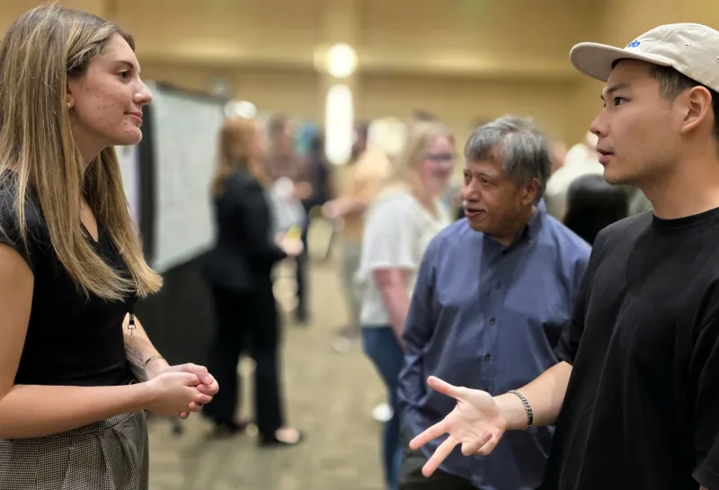 2026 summer REU students present their work at a poster session.