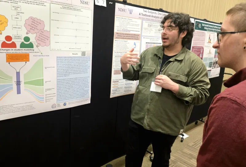 2026 summer REU students present their work at a poster session.
