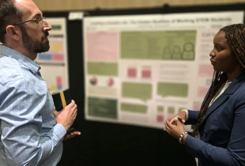2026 summer REU students present their work at a poster session.
