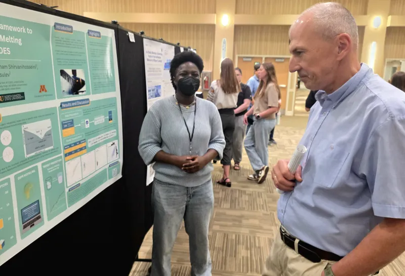 2026 summer REU students present their work at a poster session.