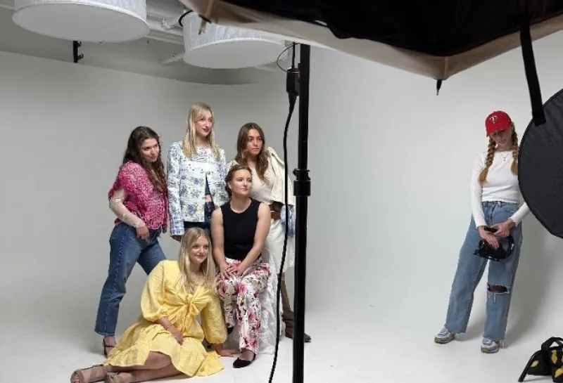 Models posing in front of camera.