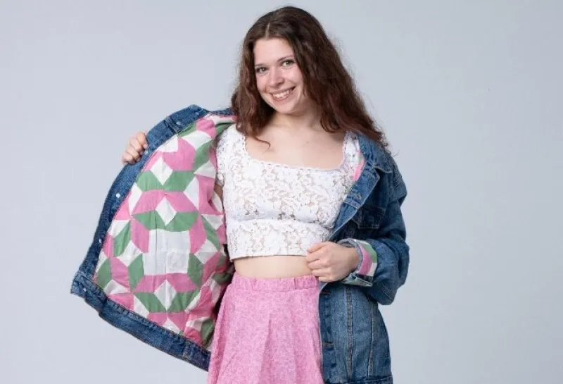 Student modeling a jean jacket.