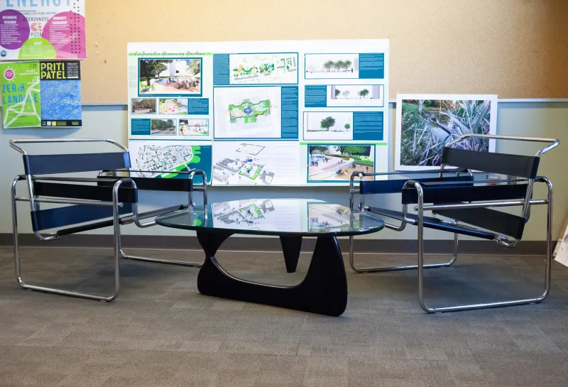 Sitting area with two chairs and glass coffee table located in Klai Hall 