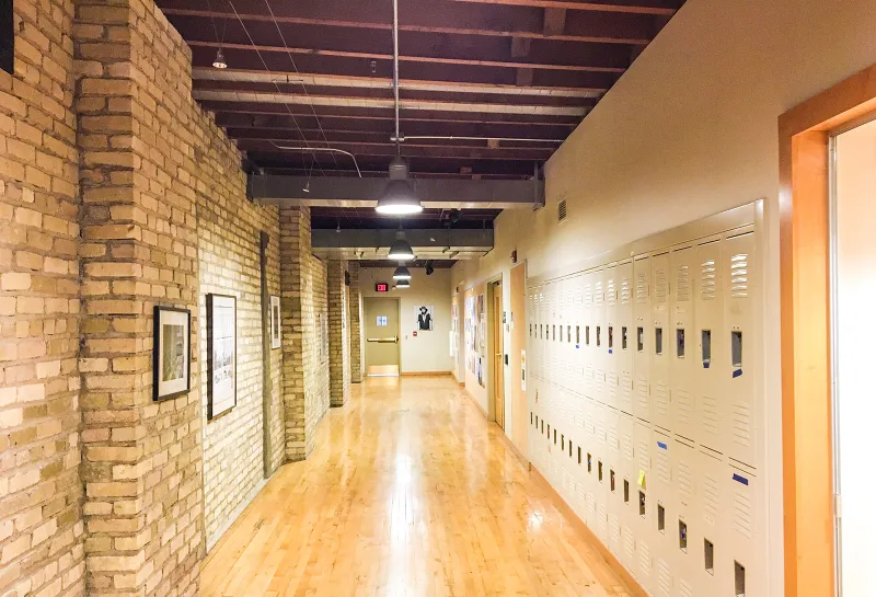 Interior brick hallway with lockers on right in Renaissance Hall.