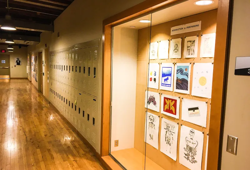 Display case with art and row of lockers in Renaissance Hall.