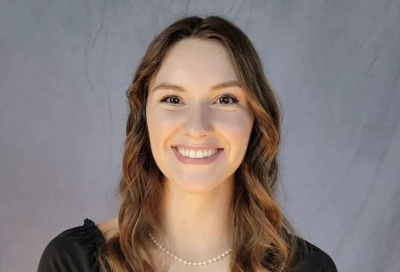 Molly smiling confidently at camera.