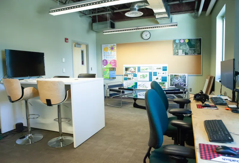 Classroom in Klai Hall with desks, chairs and computers.