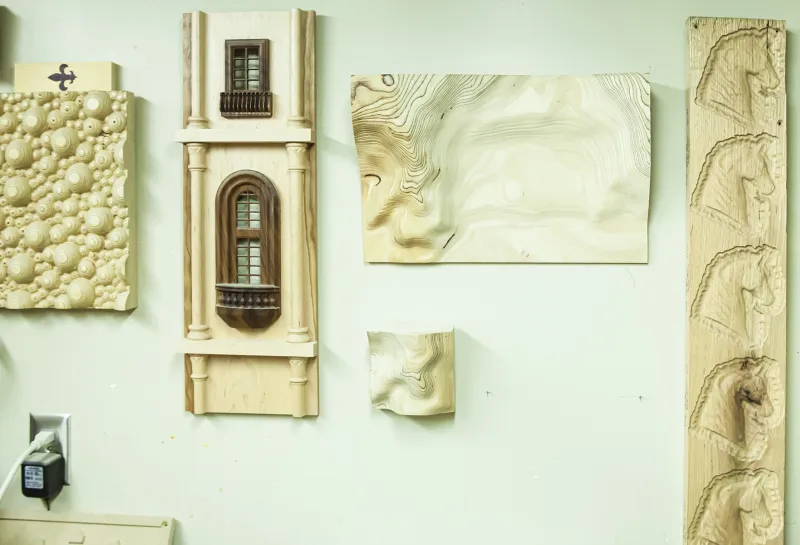 Woodshop art displayed on wall.