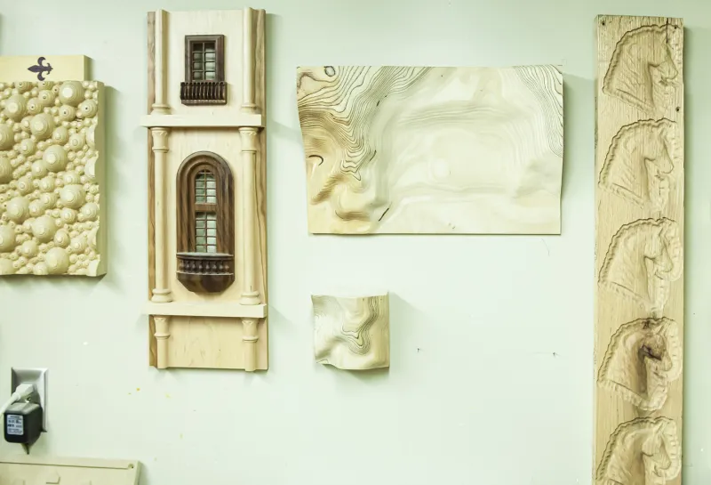 Woodshop art displayed on wall.