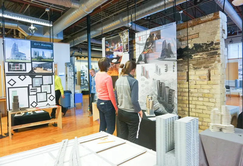 Student looking at art hanging in the 5th Floor Gallery.