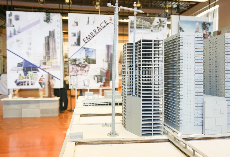 Model of building with art in the background located in the 5th Floor Gallery.