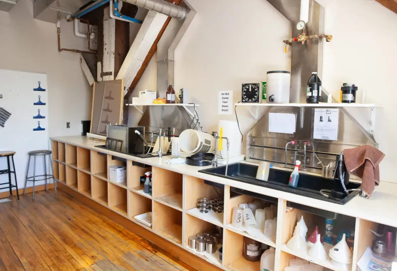 Photography studio with equipment and bench working area.