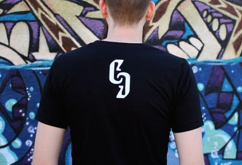 Model wearing black t-shirt with CG on back