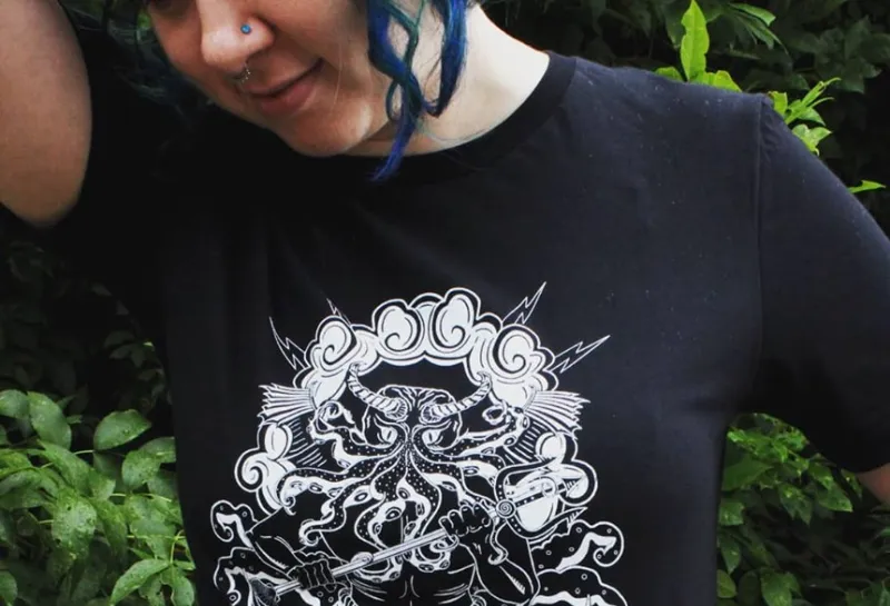 Model wearing black tshirt with artwork and 'Smooth Seas do not make Good Sailors' quote.