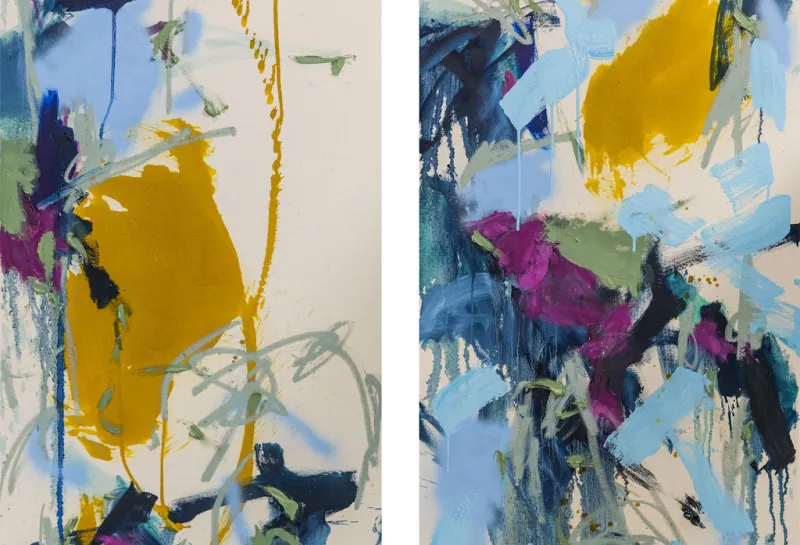 Two light colored canvases with an abstract arrangement of yellow, blue, and muted green paint