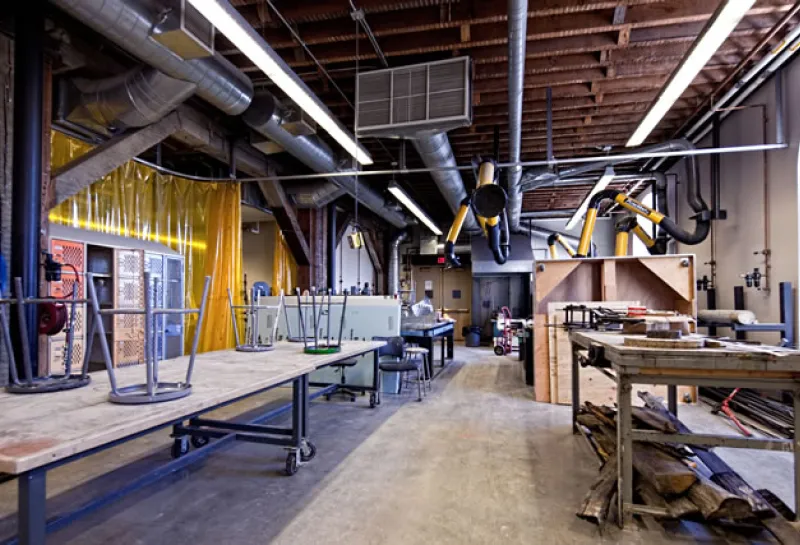 Sculpture studio with tables, stools and euipment.