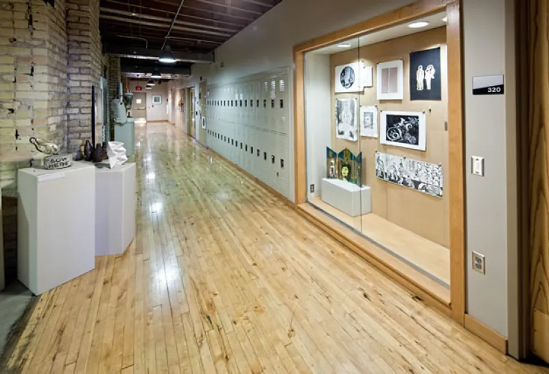 Hallway with lockers and art display case in Renaissance Hall.