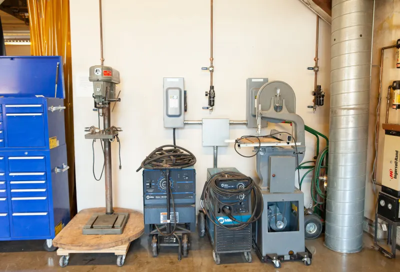 Sculpture studio euipment lined up against wall.