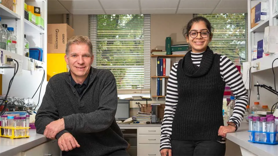 professor and doctoral student in pharmacy lab