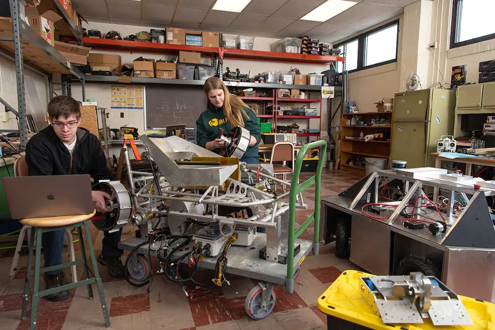 Two students working on robot
