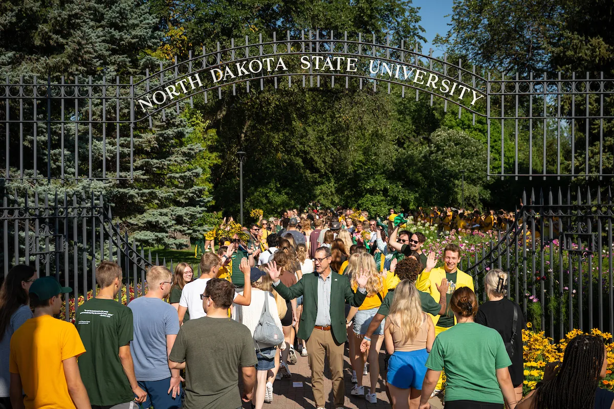 Student walking through university gates during welcome week