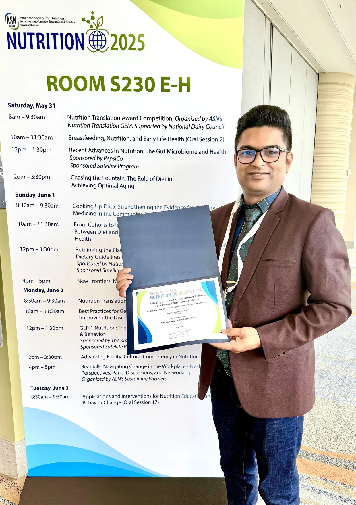 Najmol Hoque, a doctoral student in the NDSU plant sciences department, holds his award.