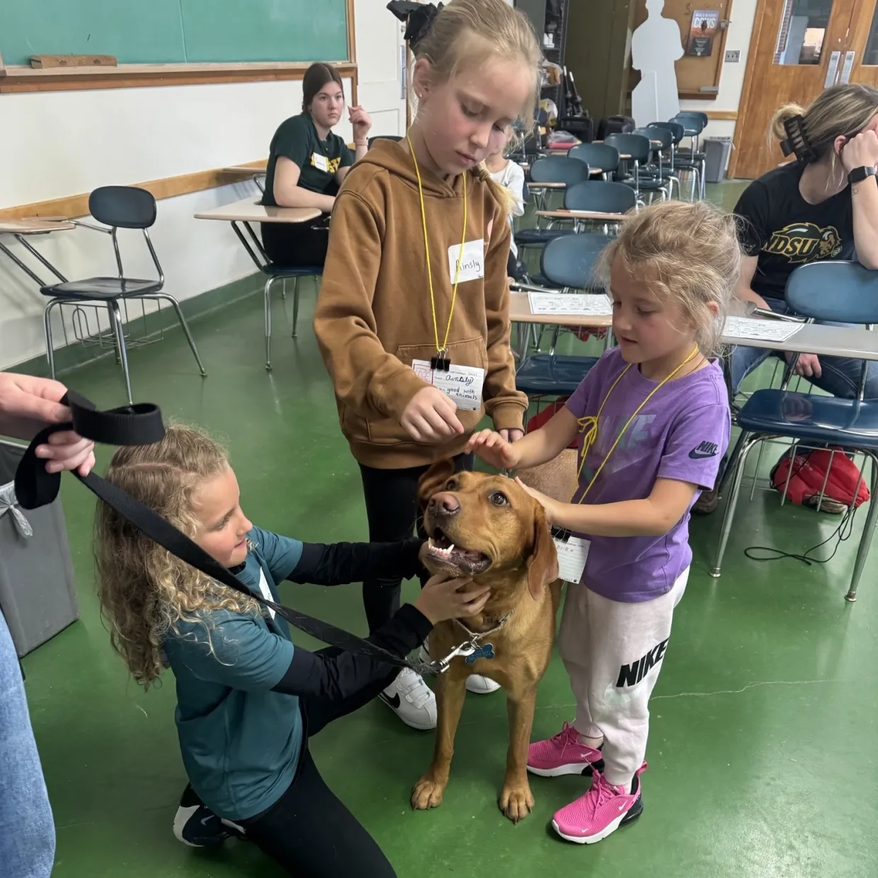 children petting dog and NDSU kids camp
