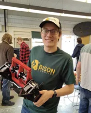 Student holding robot