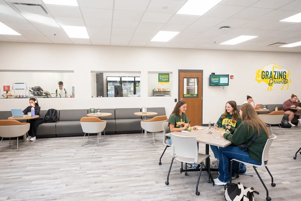 Students eating in the Grazing Grounds lounge, outside of the Micro Market.