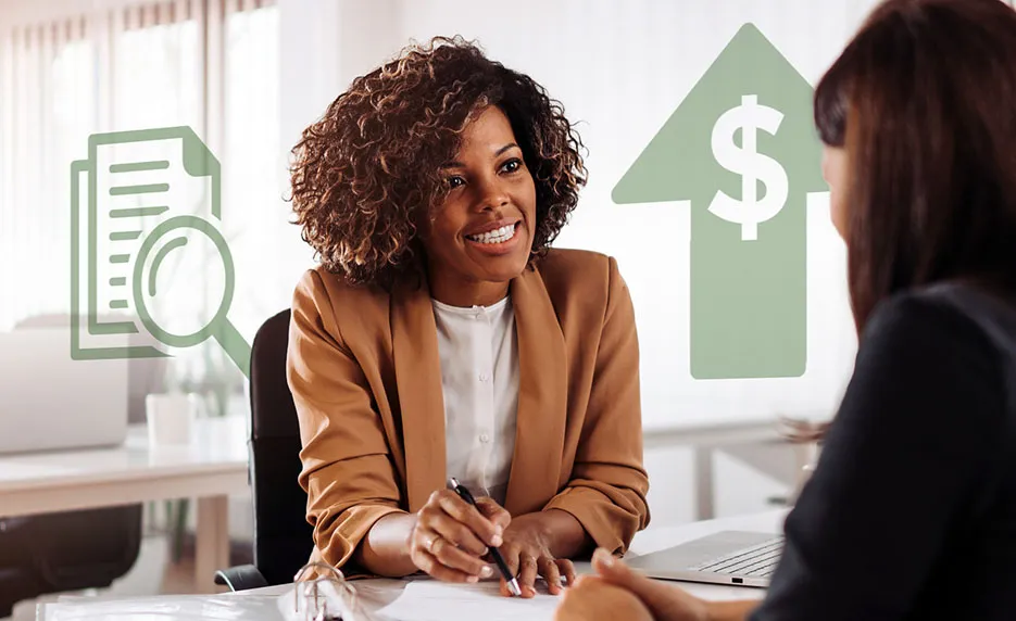 Woman working with a customer pointing to paperwork with a pen
