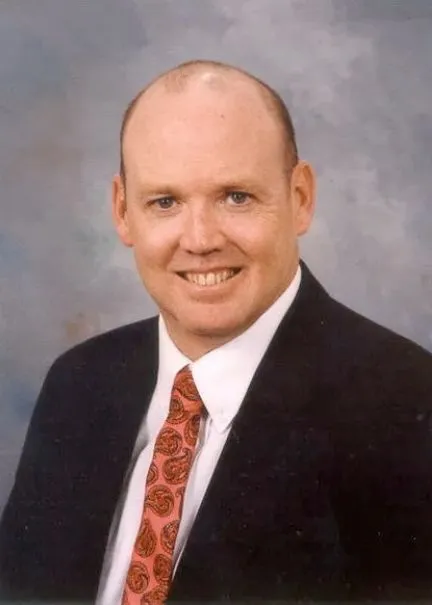 Hearne smiling confidently at camera.