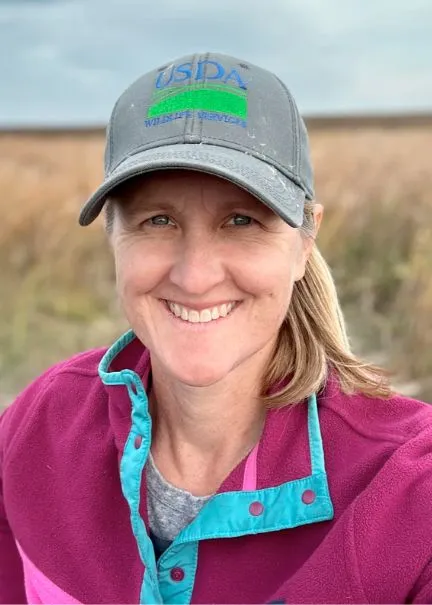 Page Klug smiling confidently at camera.