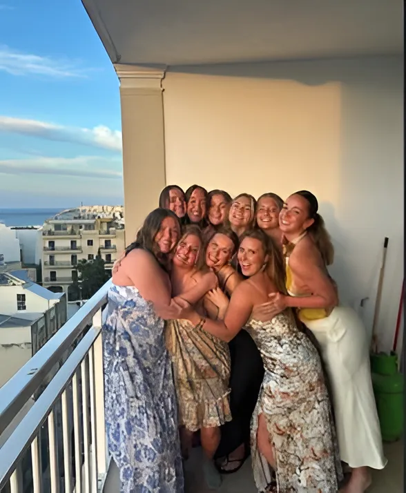 group of ten students on a balcony