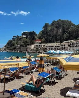 A beach with a lot of chairs and umbrellas on a sunny day.
