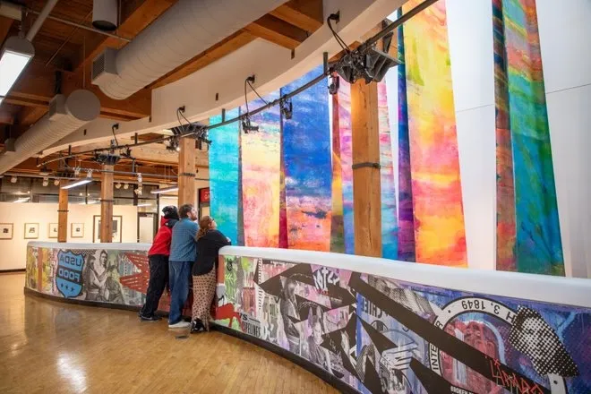 People looking at an art exhibit at the Plains Art Museum