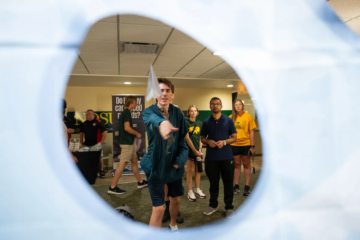 NDSU student participates in paper airplane challenge during Saturday Night Live.