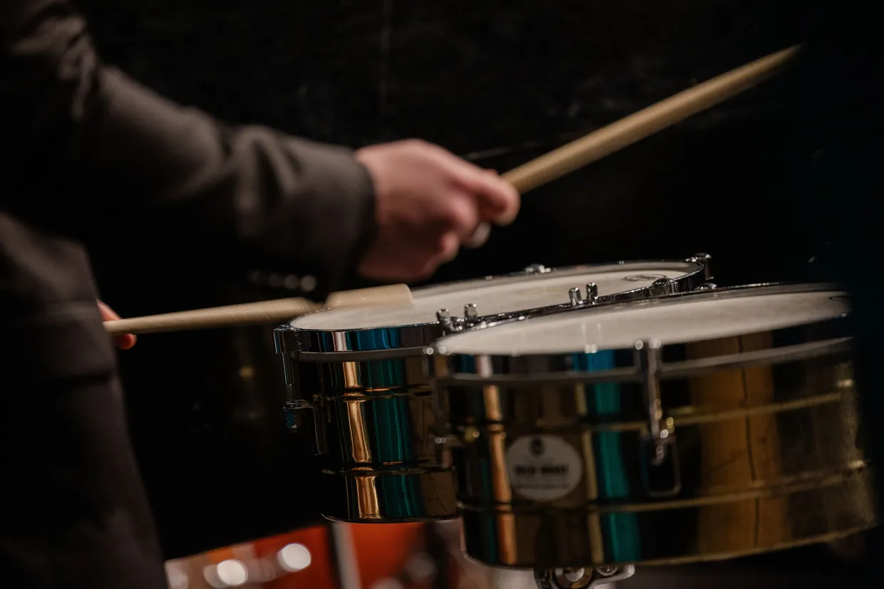 A closeup of a student playing drums in the NDSU Jazz Ensemble